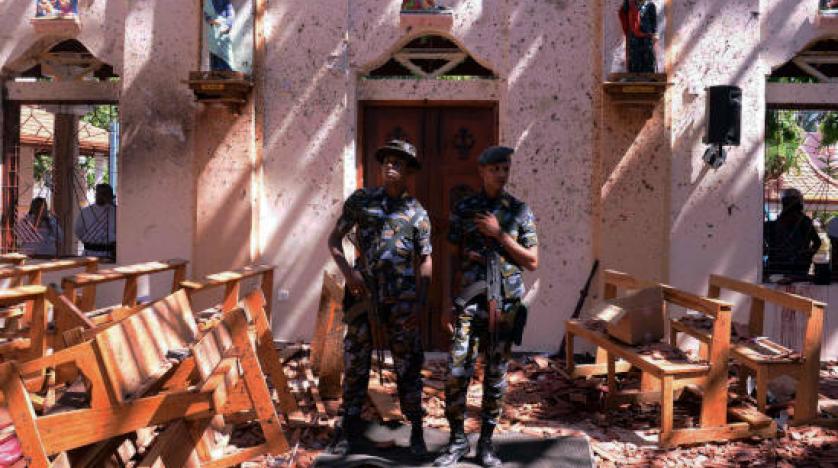 Sri Lankan military stand guard inside a church after an explosion in Negombo reuters