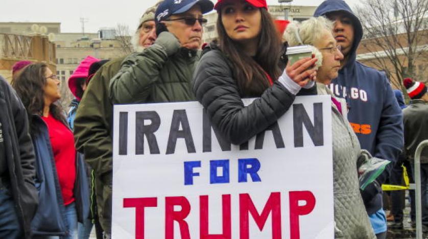 A woman from Iran who supports Trump waits in line to enter a Trump campaign rally epa